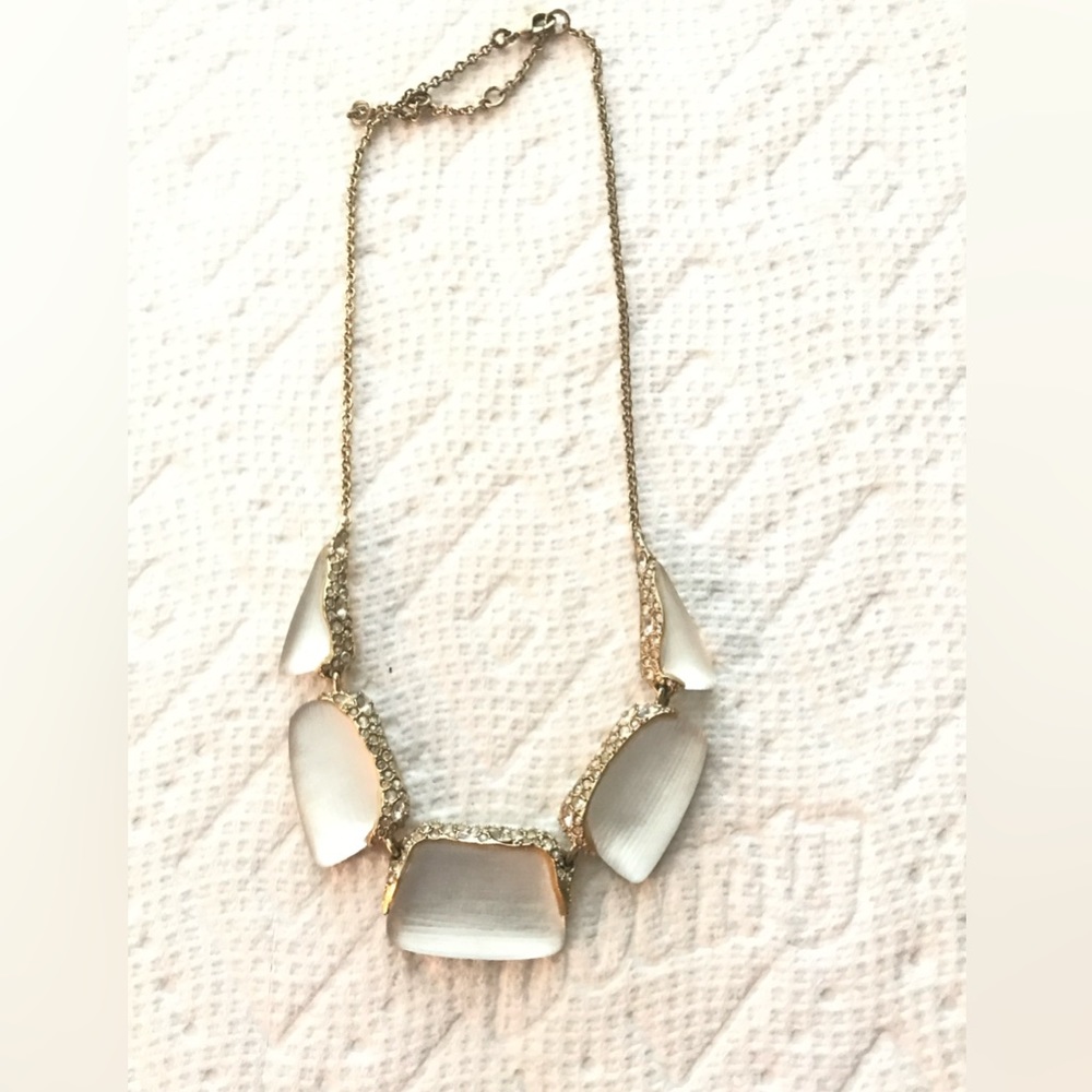 Alexis Bittar white lucite necklace with crystals in gold tone setting.